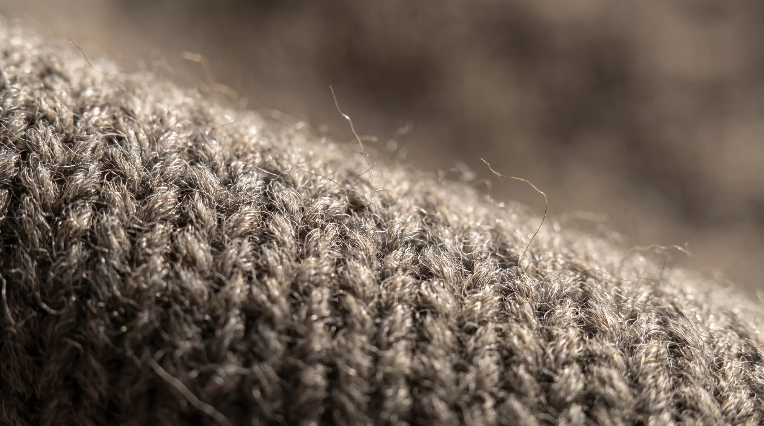 A close photograph of grey ribbed wool